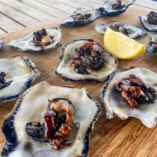 Oysters Kilpatrick cooked in a frying pan
