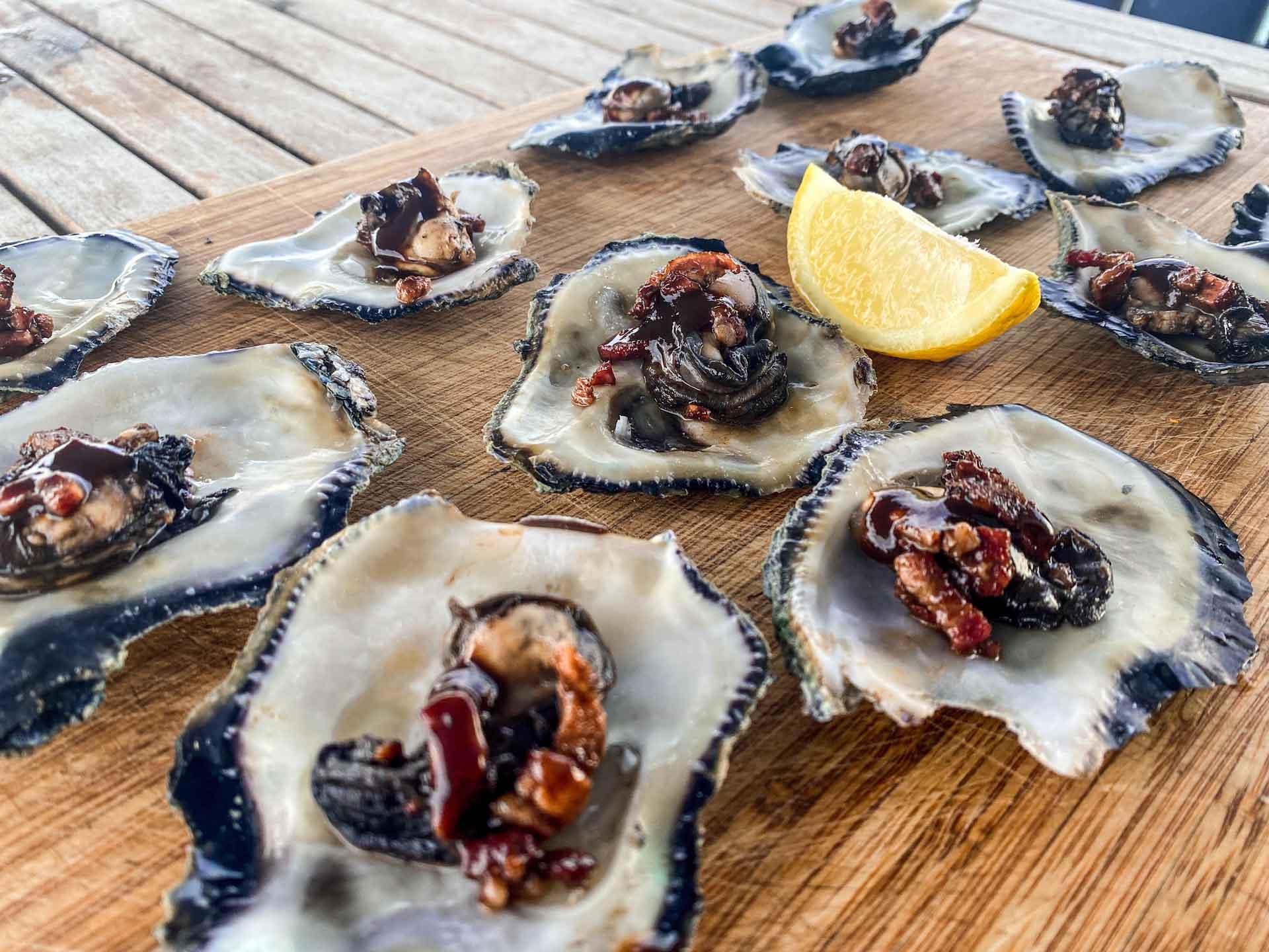 Oysters Kilpatrick cooked in a frying pan